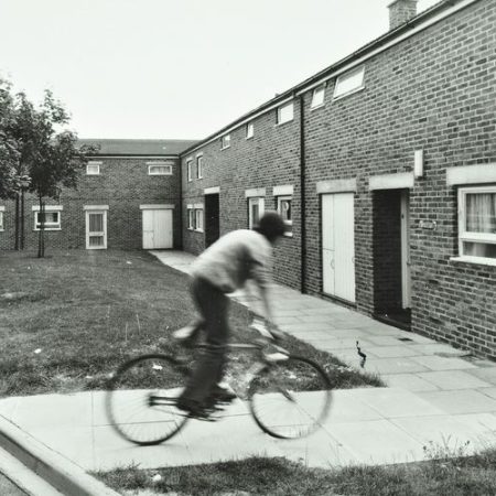 Andover: boy rides a bicycle on a housing estate, image © London Metropolitan Archives (City of London).